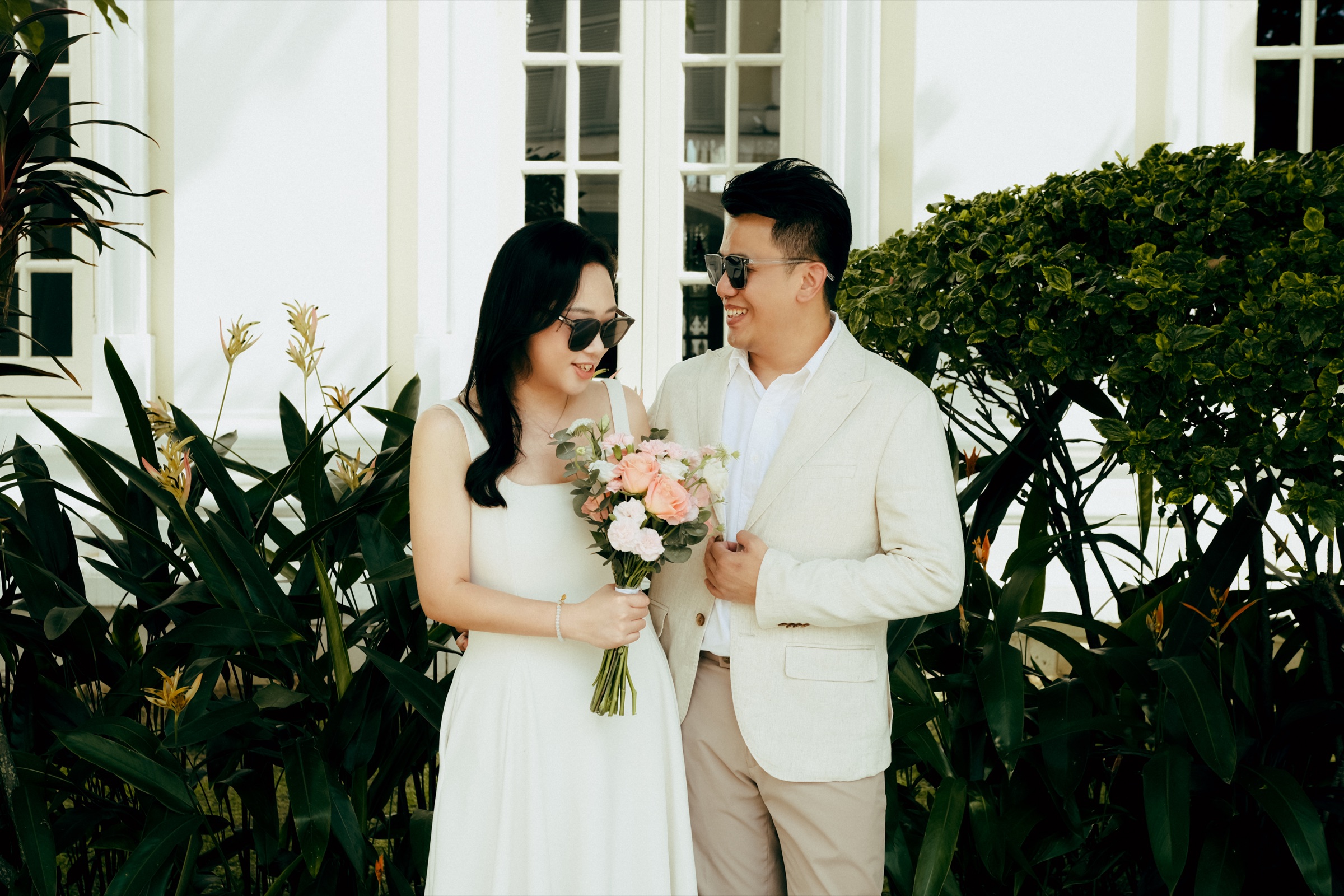 Teck Seng and Li Ting dressed in white by the garden